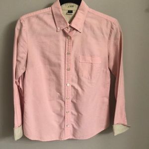Pink button down shirt with pattern under sleeve